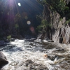 Water falls off the waterfall on a lovely summers day. 