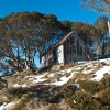 Cope Hut in spring with a bit of snow still on the ground.